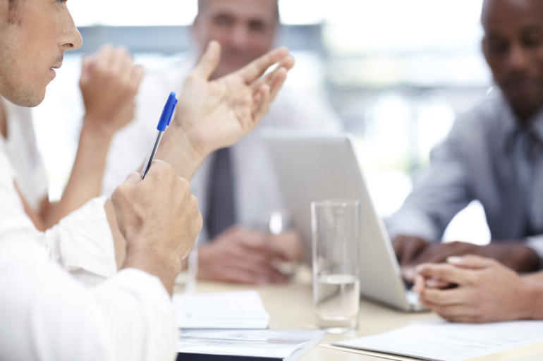 A group of businesspeople brainstorming together in the boardroom